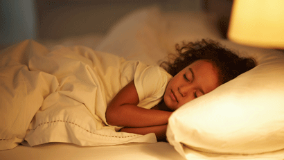 Little girl asleep in bed