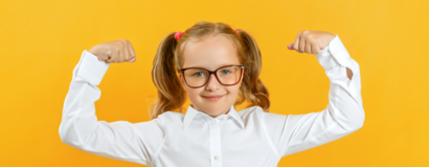 Schoolgirl in uniform flexing muscles to demonstrate strength