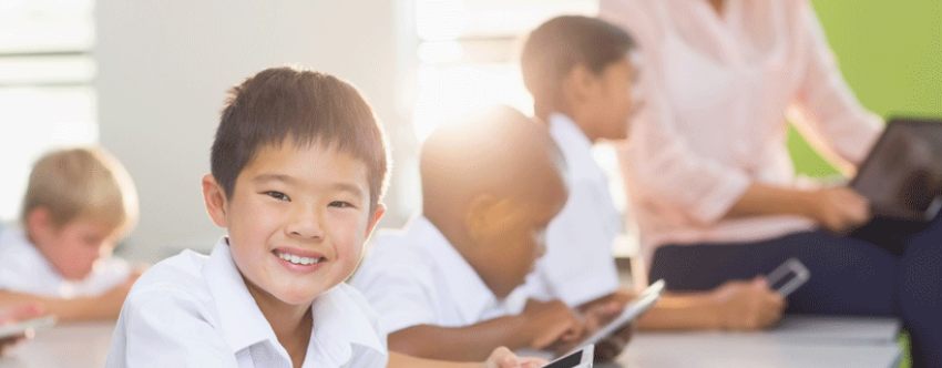 Primary school children using smartphones with the teacher's supervision.